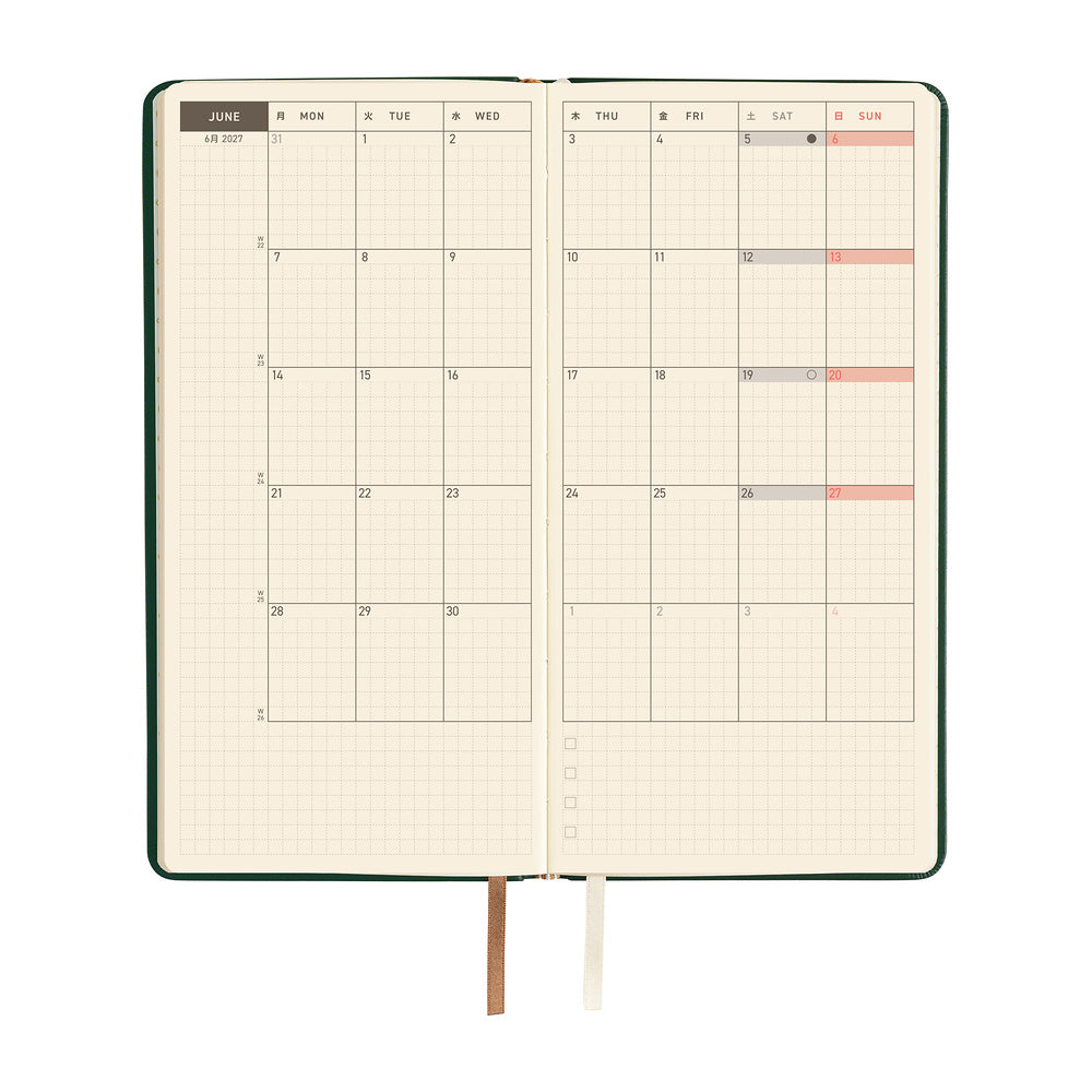 An open planner showing a two-page monthly calendar on cream pages.