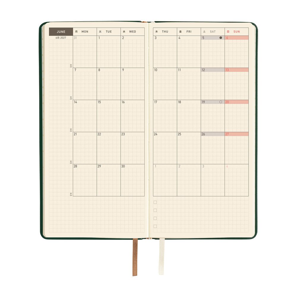 An open planner showing a two-page monthly calendar on cream pages.