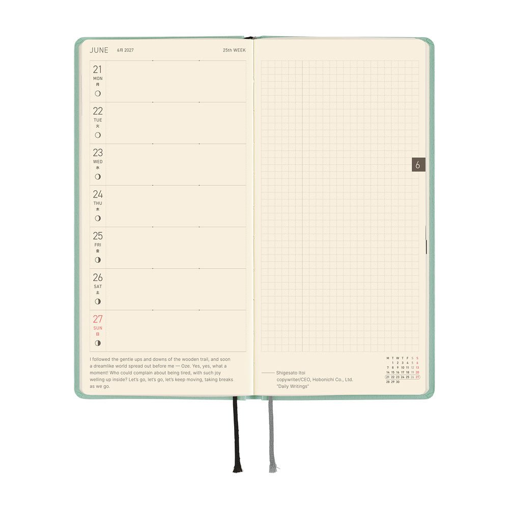 An open planner showing two interior pages: the left page has a weekly schedule layout for June 21st through 27st, and the right page has a grid.