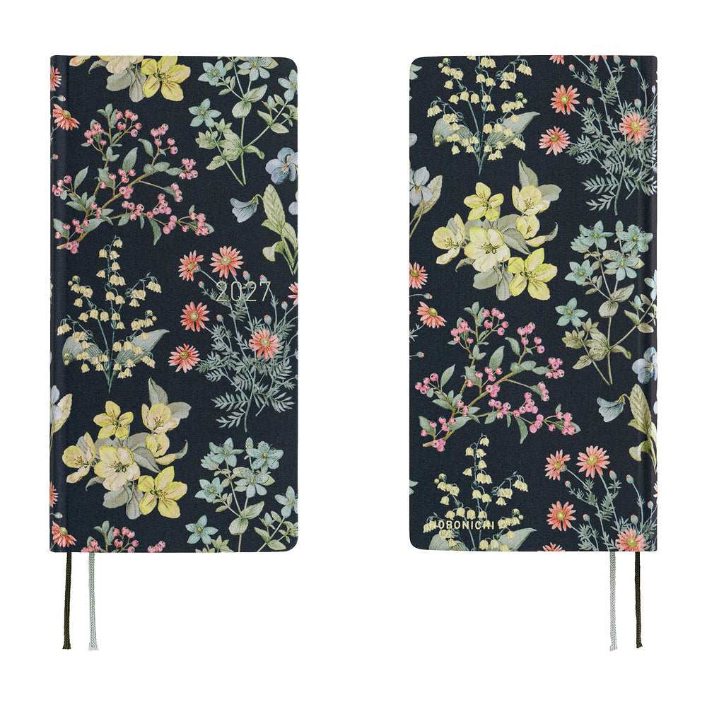 Front and back views of a 2027 planner covered in fabric featuring a botanical design on a dark background by Liberty Fabrics.