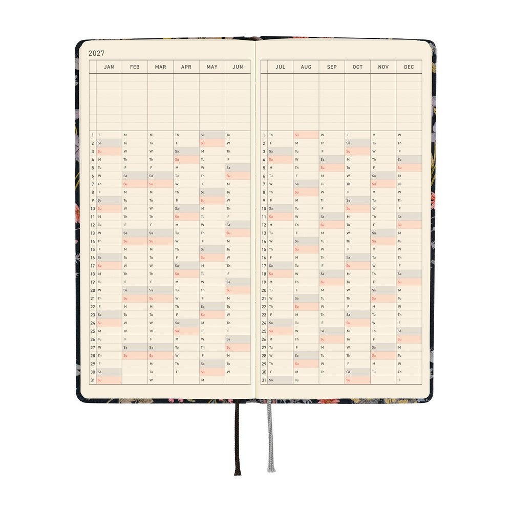 An open 2027 daily planner with cream-colored pages showing a yearly calendar grid over a two-page spread.