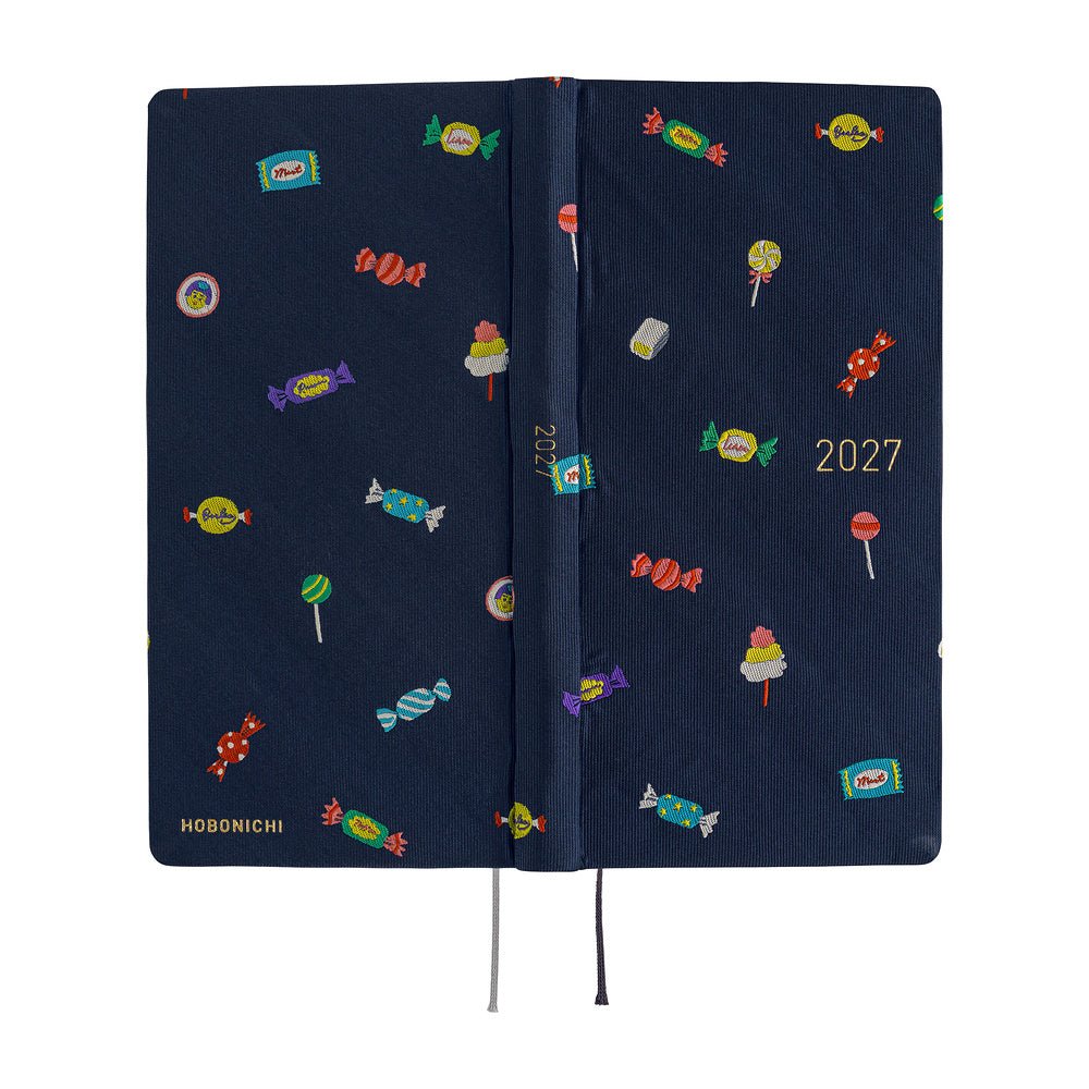 A 2027 Hobonichi Weeks Mega featuring Bow & Tie fabric woven with candy designs.