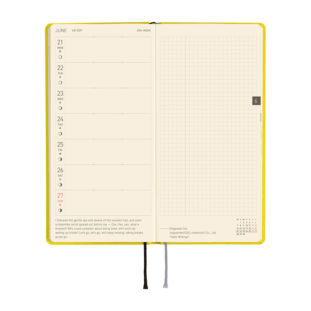 An open weekly planner spread showing a Monday through Sunday layout on the left page and a grid ruled page on the right.
