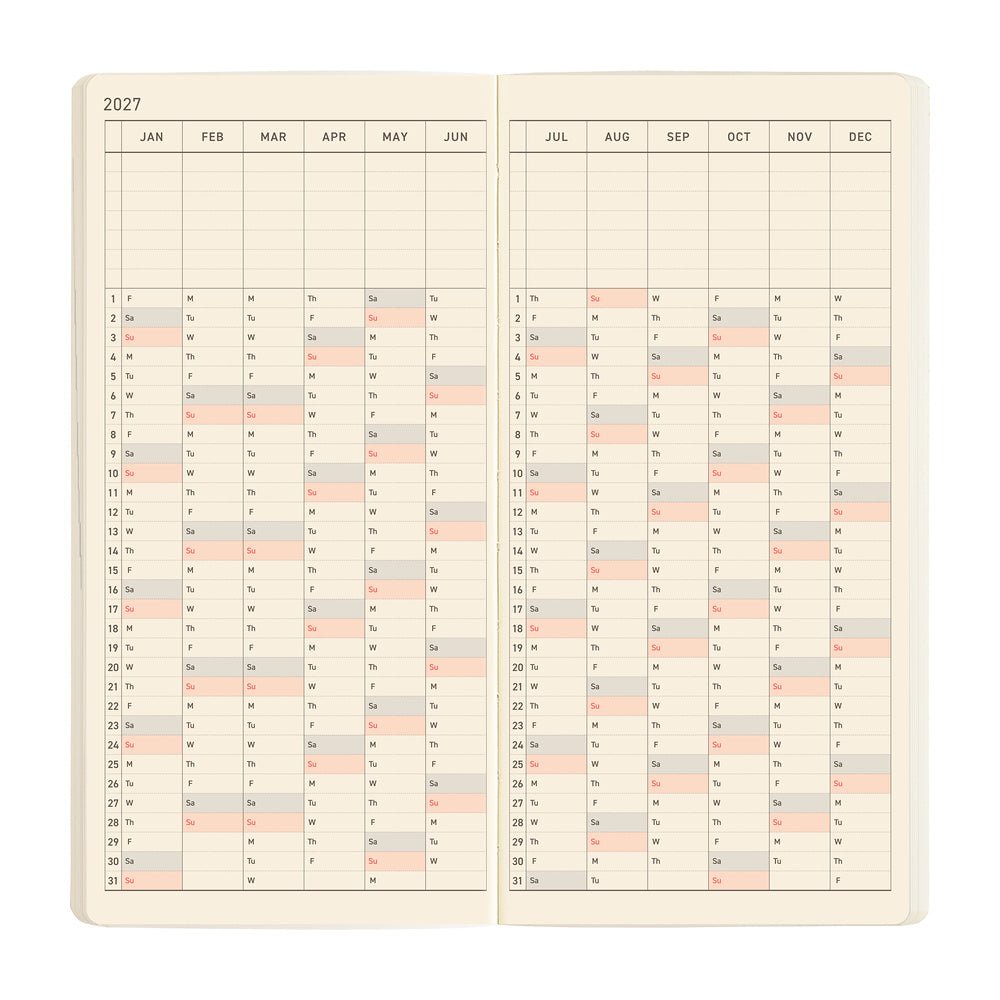 An open planner showing a two-page yearly calendar, arranged vertically on cream colored pages.