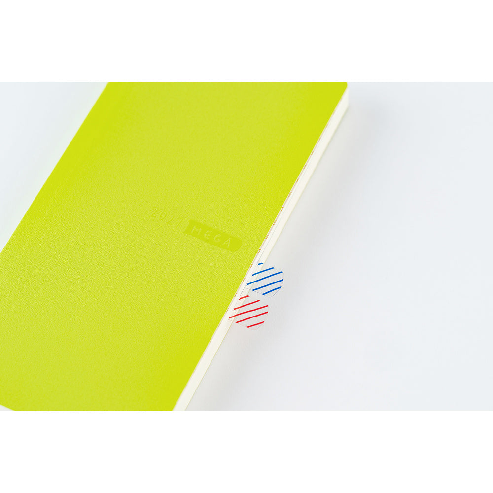 A close up of a lime green planner showing an example of how adhesive tabs can be used to tag pages.