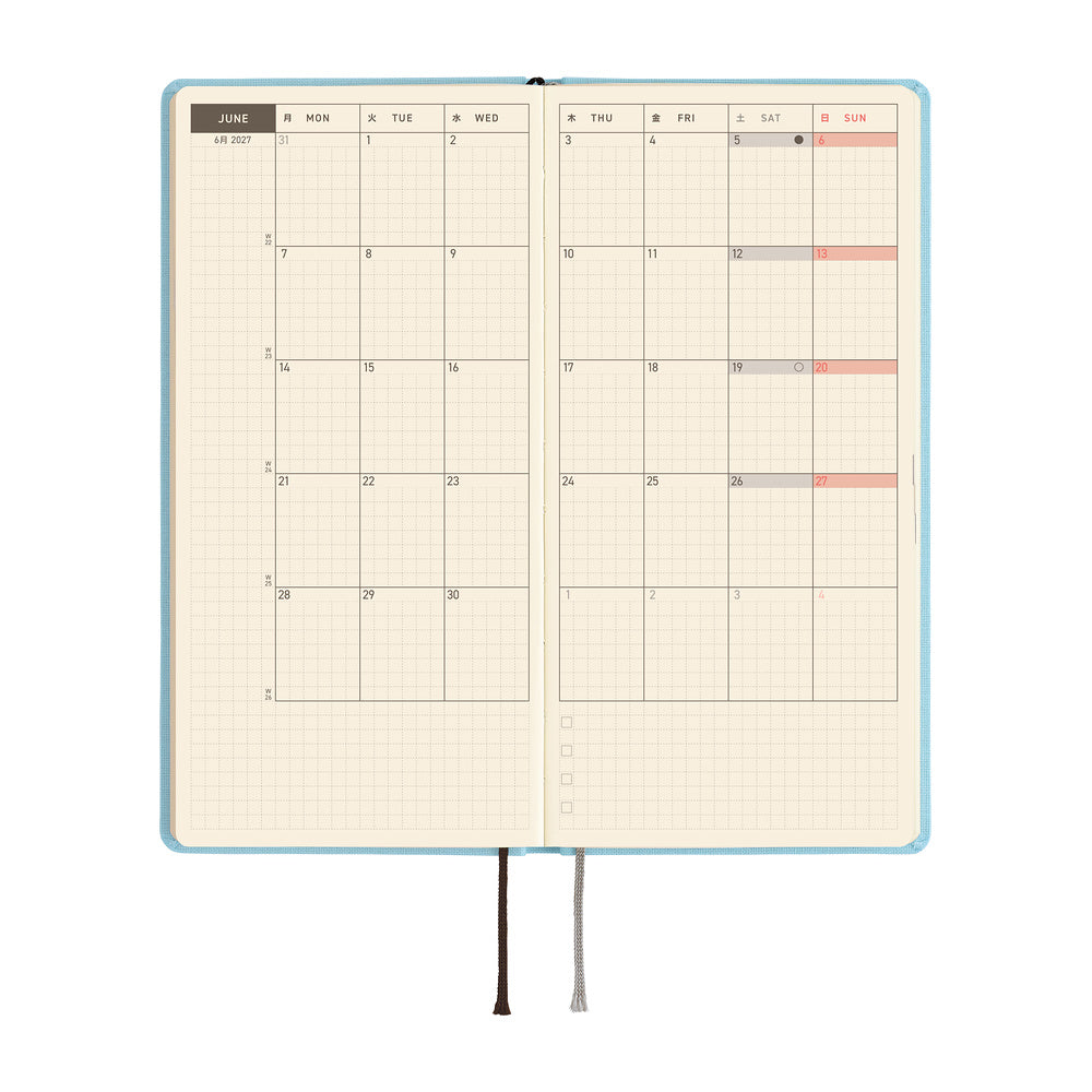 An open planner showing a two-page monthly calendar spread on cream colored paper.