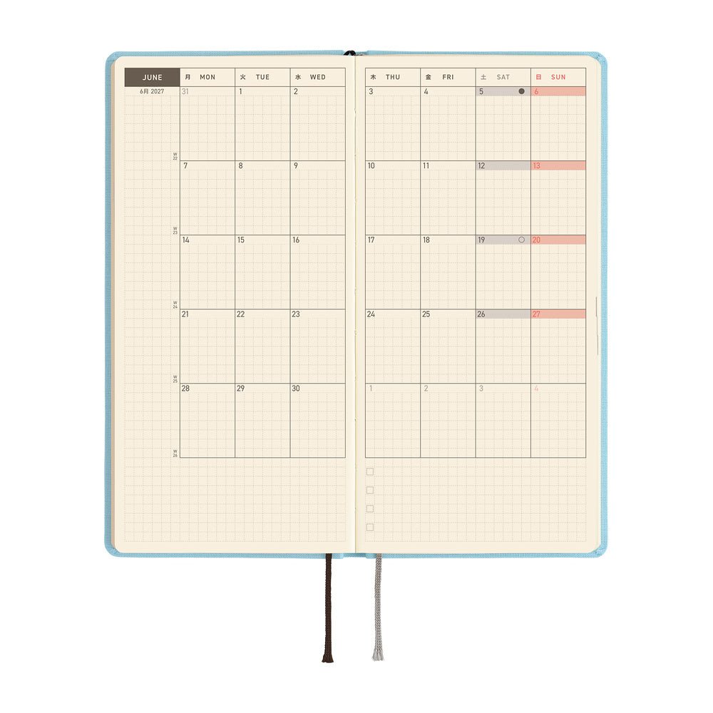 An open planner showing a two-page monthly calendar spread on cream colored paper.