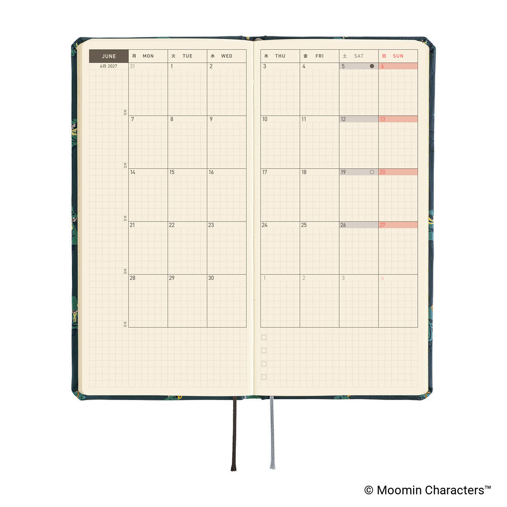 An open planner showing a monthly calendar spread with cream grid pages. A ribbon bookmark hangs from the bottom.