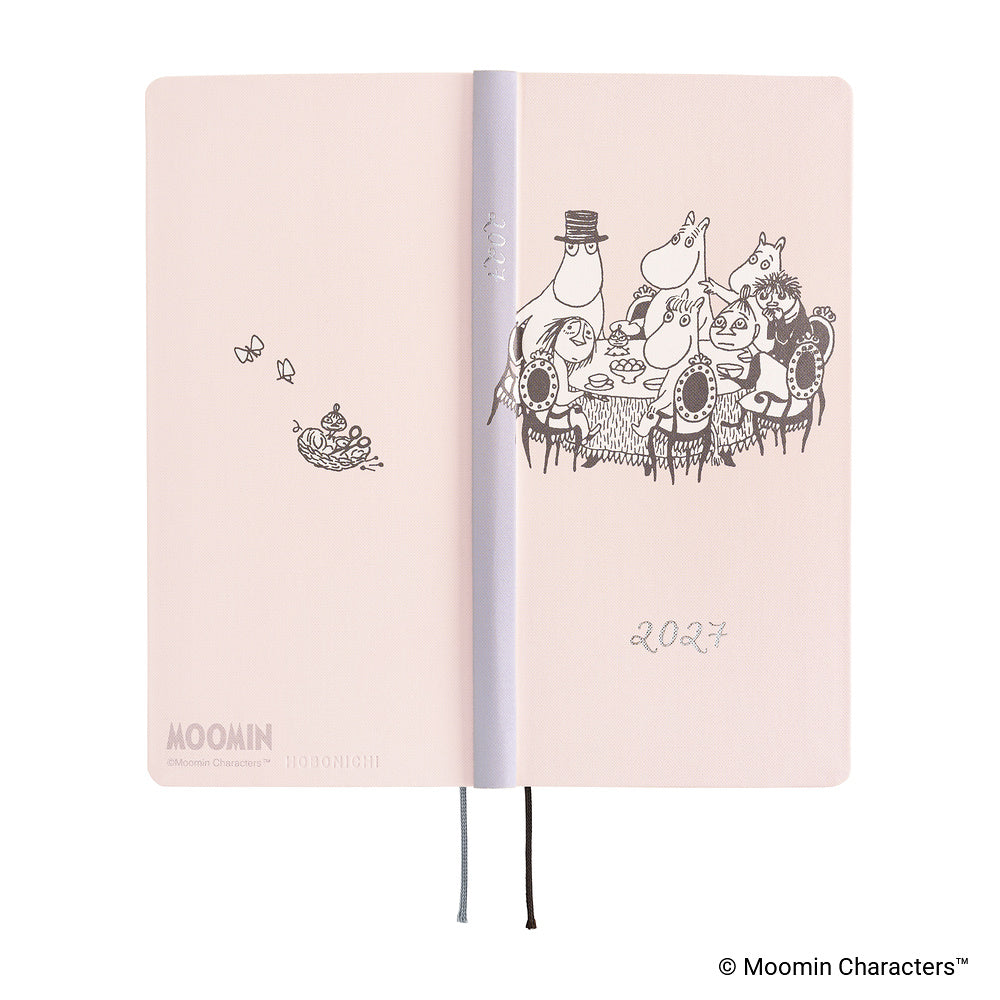 A pale pink Moomin 2027 daily planner shown open, featuring black line-art illustrations of Moomin characters.