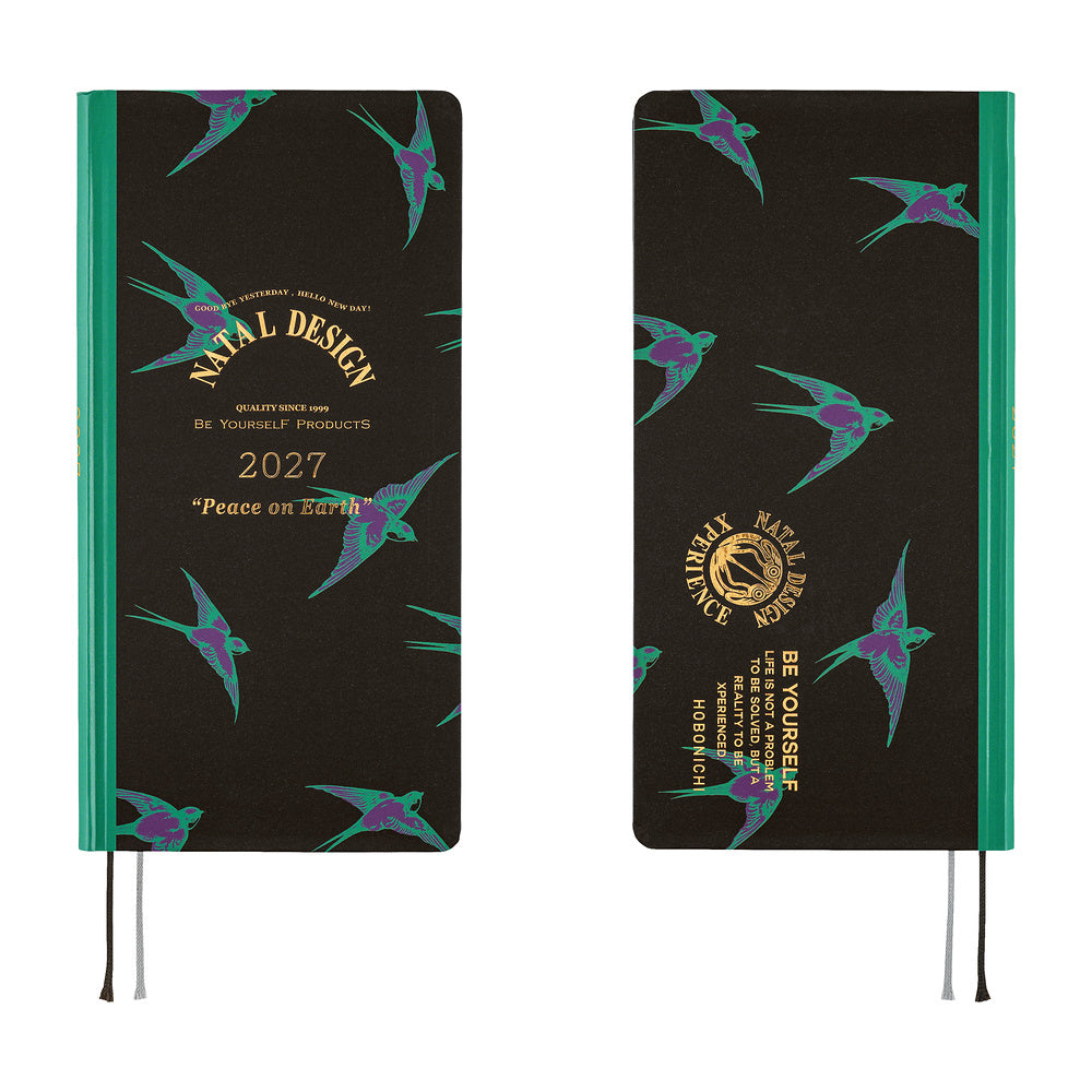 A 2027 planner shown from the front and back on a white background. The cover is black with a teal and purple bird pattern, a teal spine band, and gold text reading 'Natal Design' and '2027 Peace on Earth.