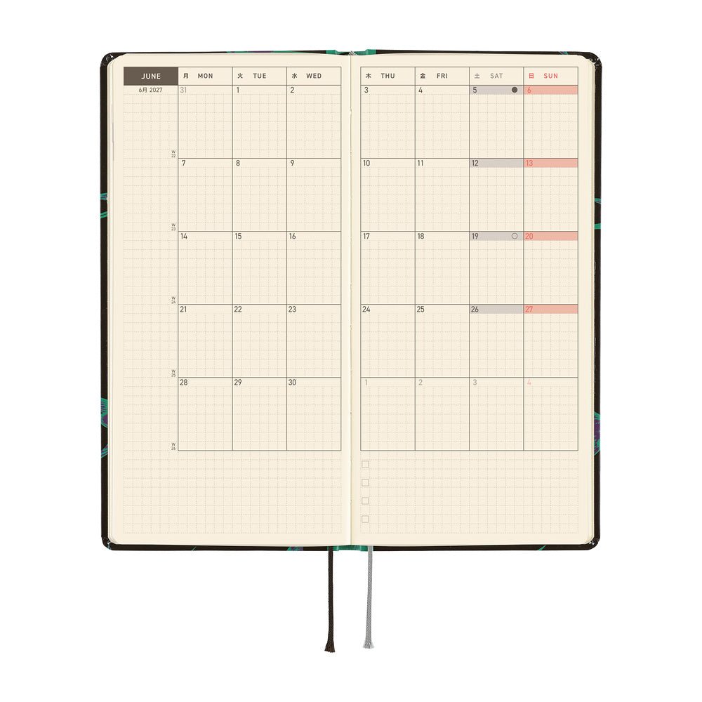 An open planner showing a two-page monthly calendar spread on cream grid pages.