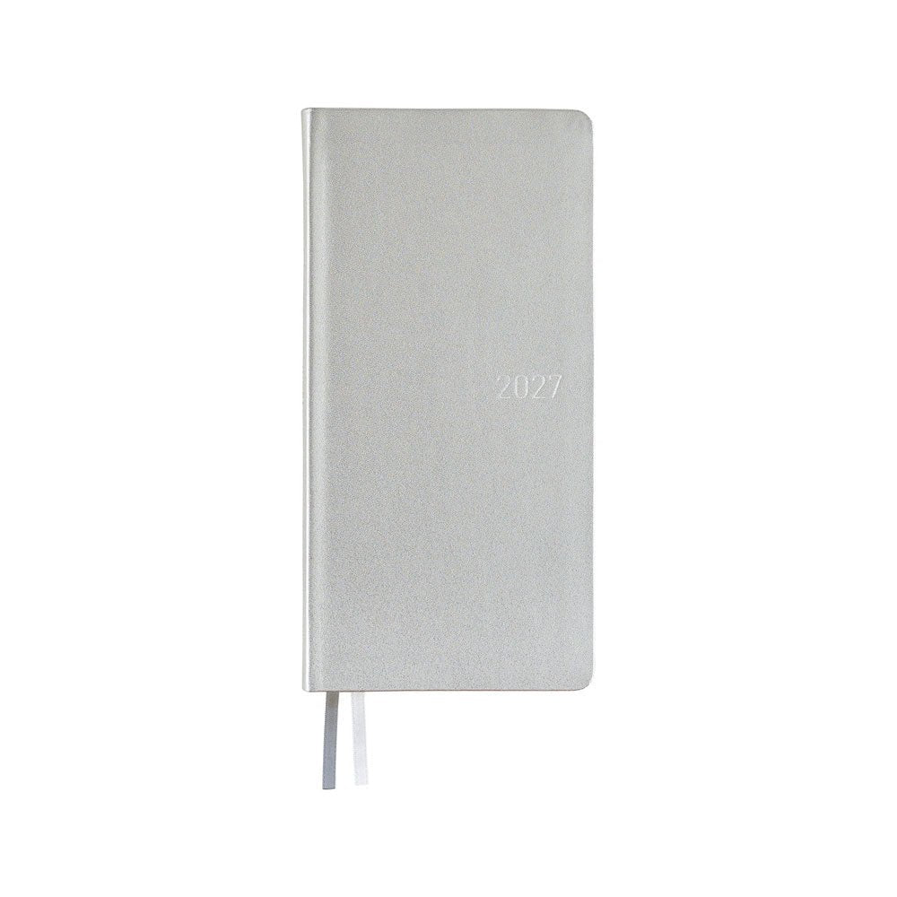 A slim 2027 daily planner with a silver leather cover, featuring a thin ribbon bookmarks, shown against a plain white background.
