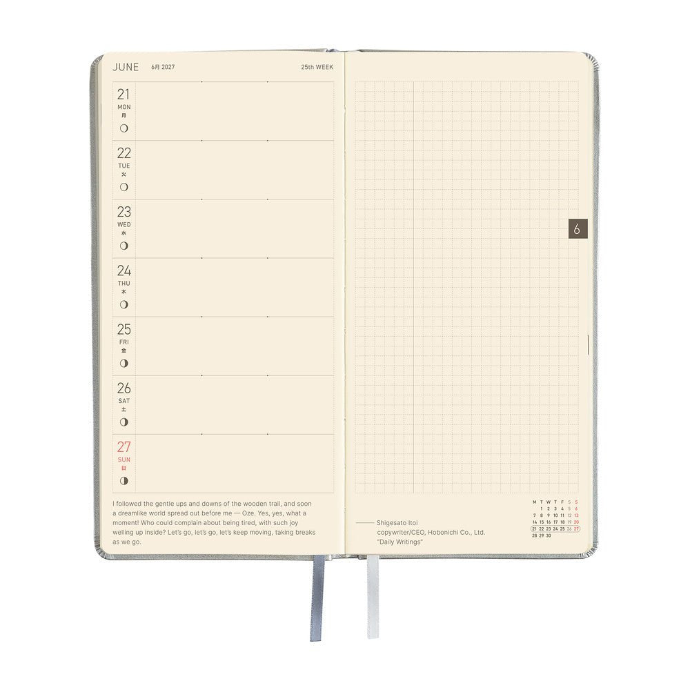 An open daily planner showing a two-page spread with a cream-colored left page featuring a weekly layout and a right page with a grid layout.