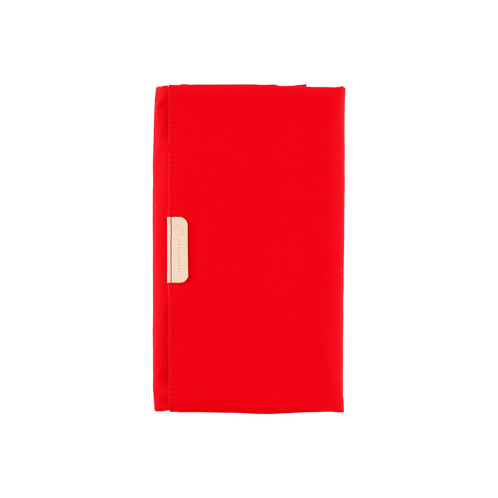 Bright red Tragen Hobonichi Techo Weeks cover on white background