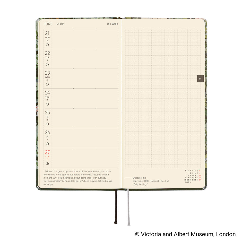An open planner showing two interior pages: a weekly layout on the left with cream paper and a light grid page on the right.