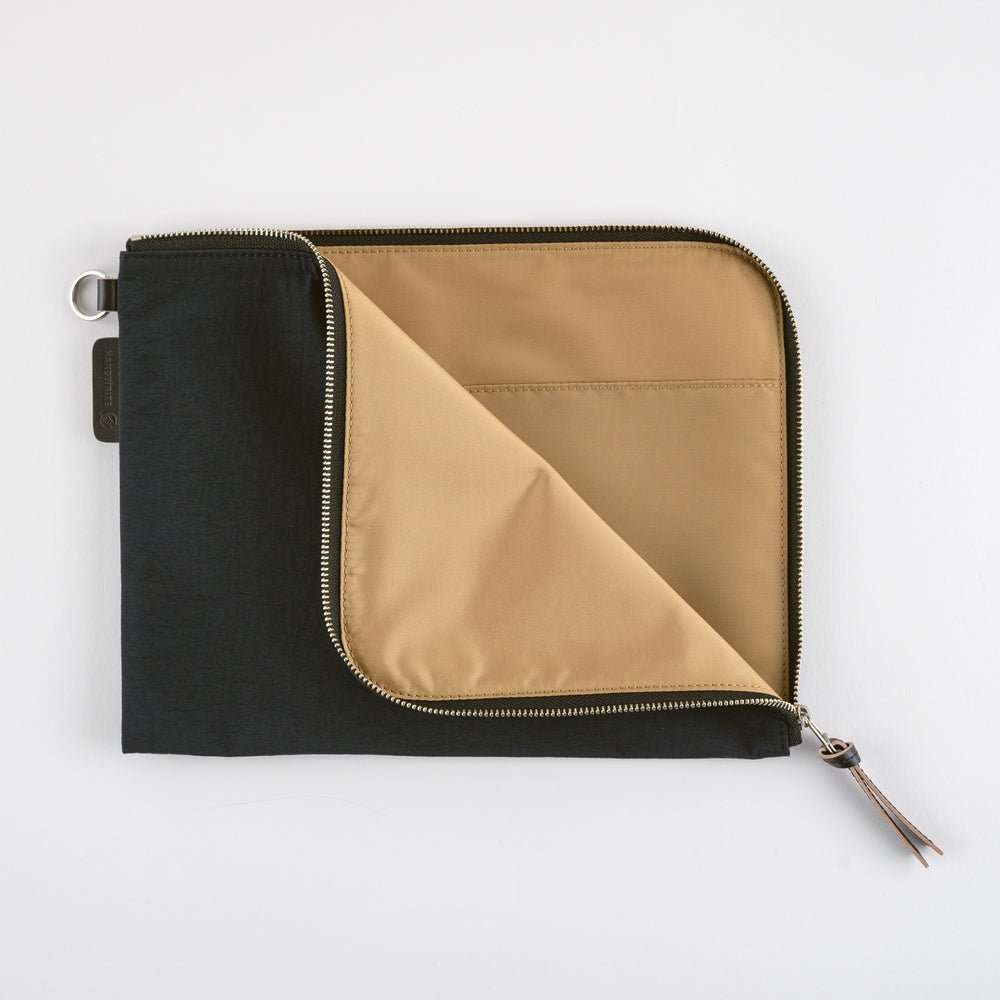 Black and beige zippered pouch on a white background