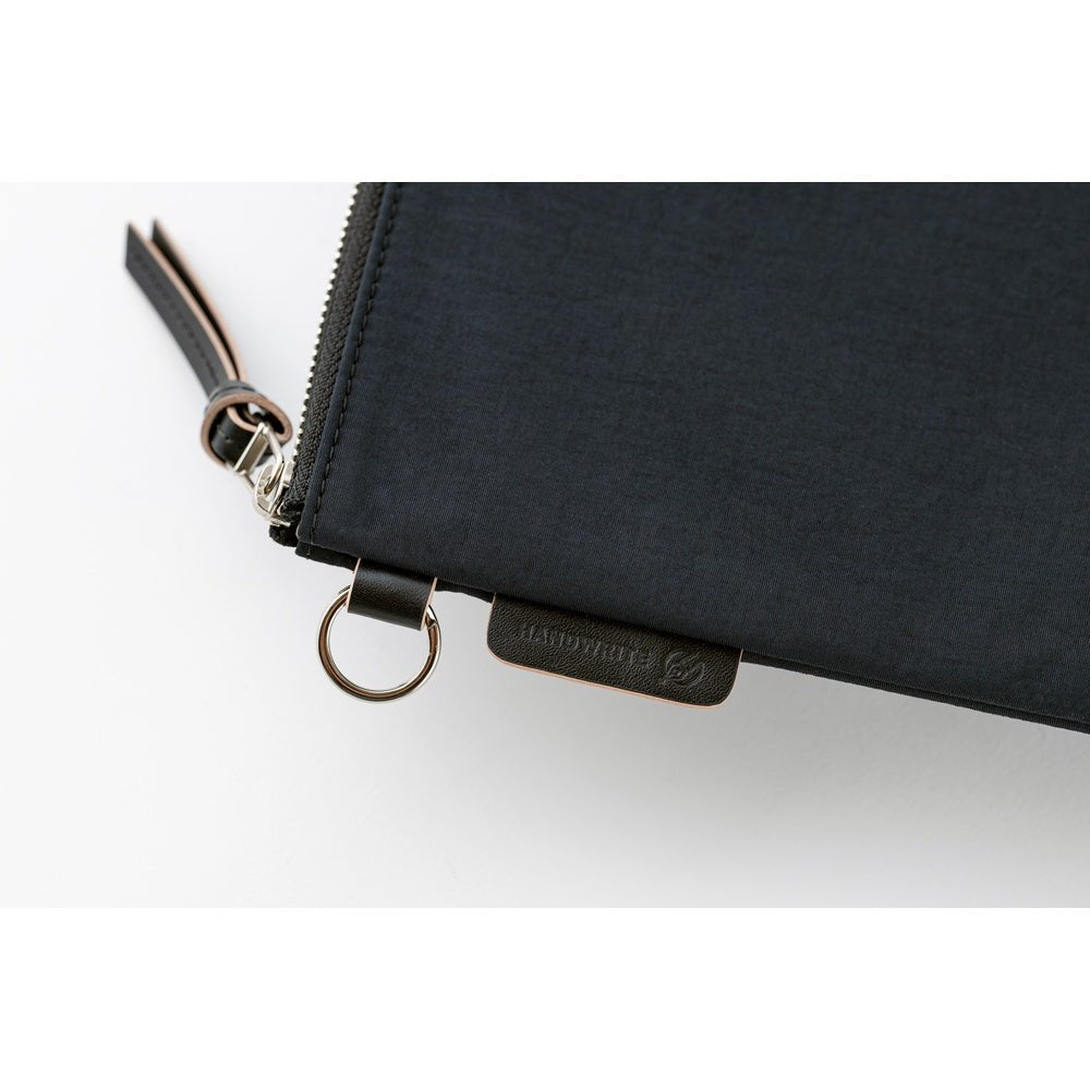 Black zippered pouch with a visible brand logo on a white background