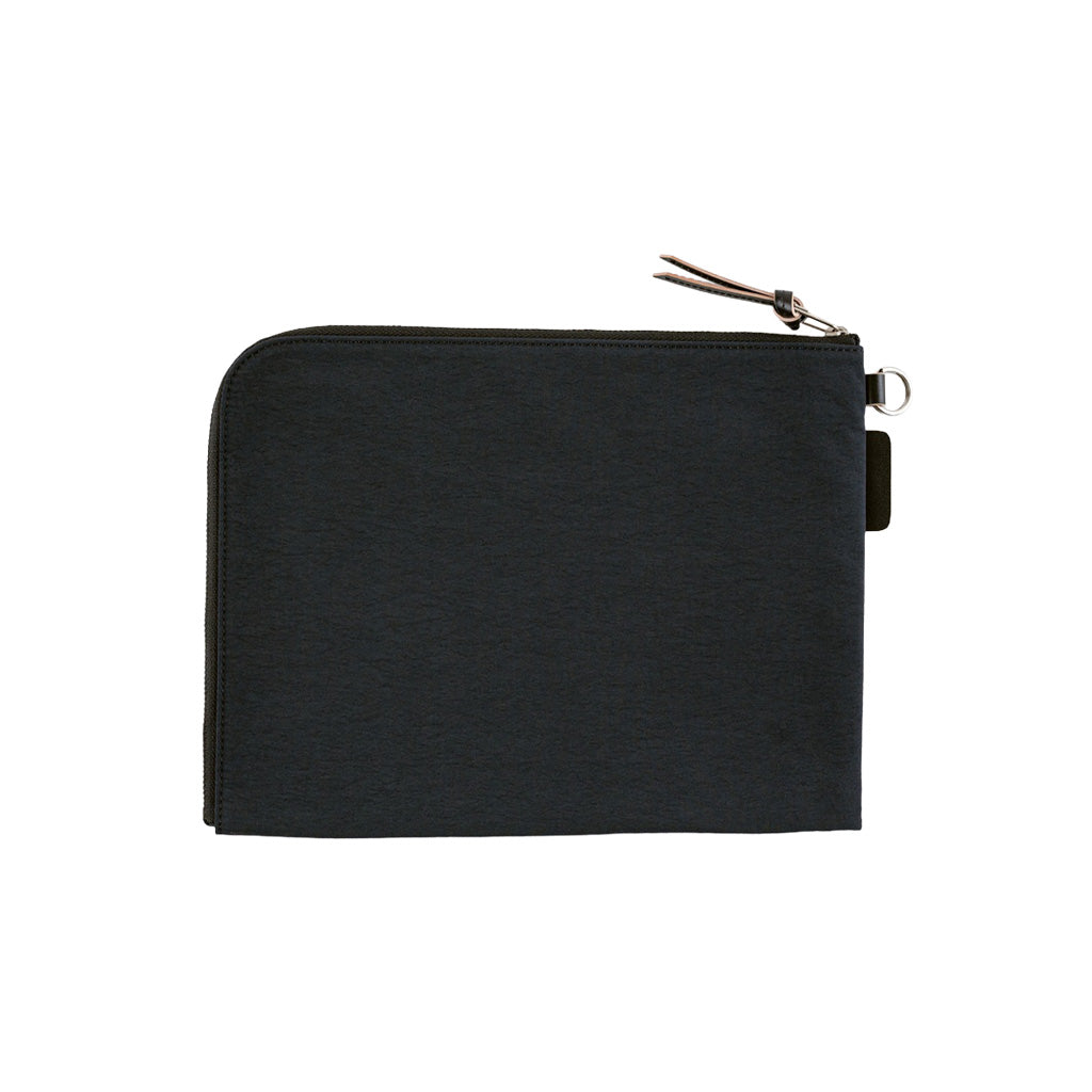 A black A6 zippered Tragen flat pouch on white background