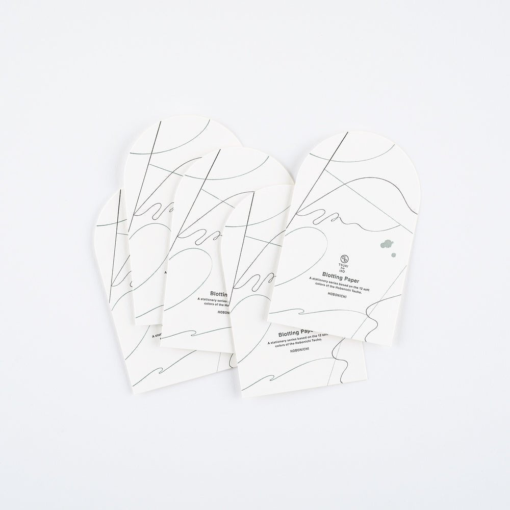 Four arched sheets of blotting paper shown on a clean white background. The papers feature minimalist black abstract line art and text detailing its features.
