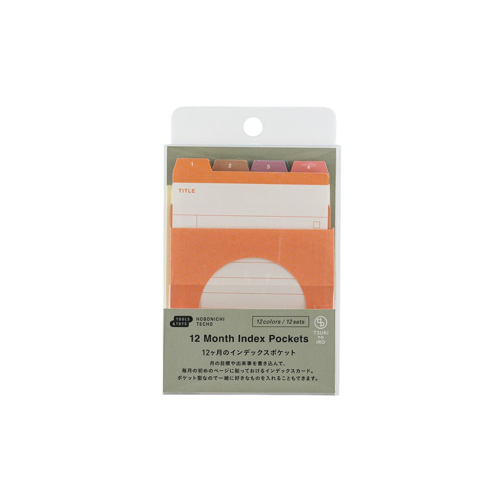 A package of 12 Month Index Pockets by TSUKI no IRO, containing 12 colored tabs in various shades of orange, pink, purple, and green, presented in its retail packaging against a white background.