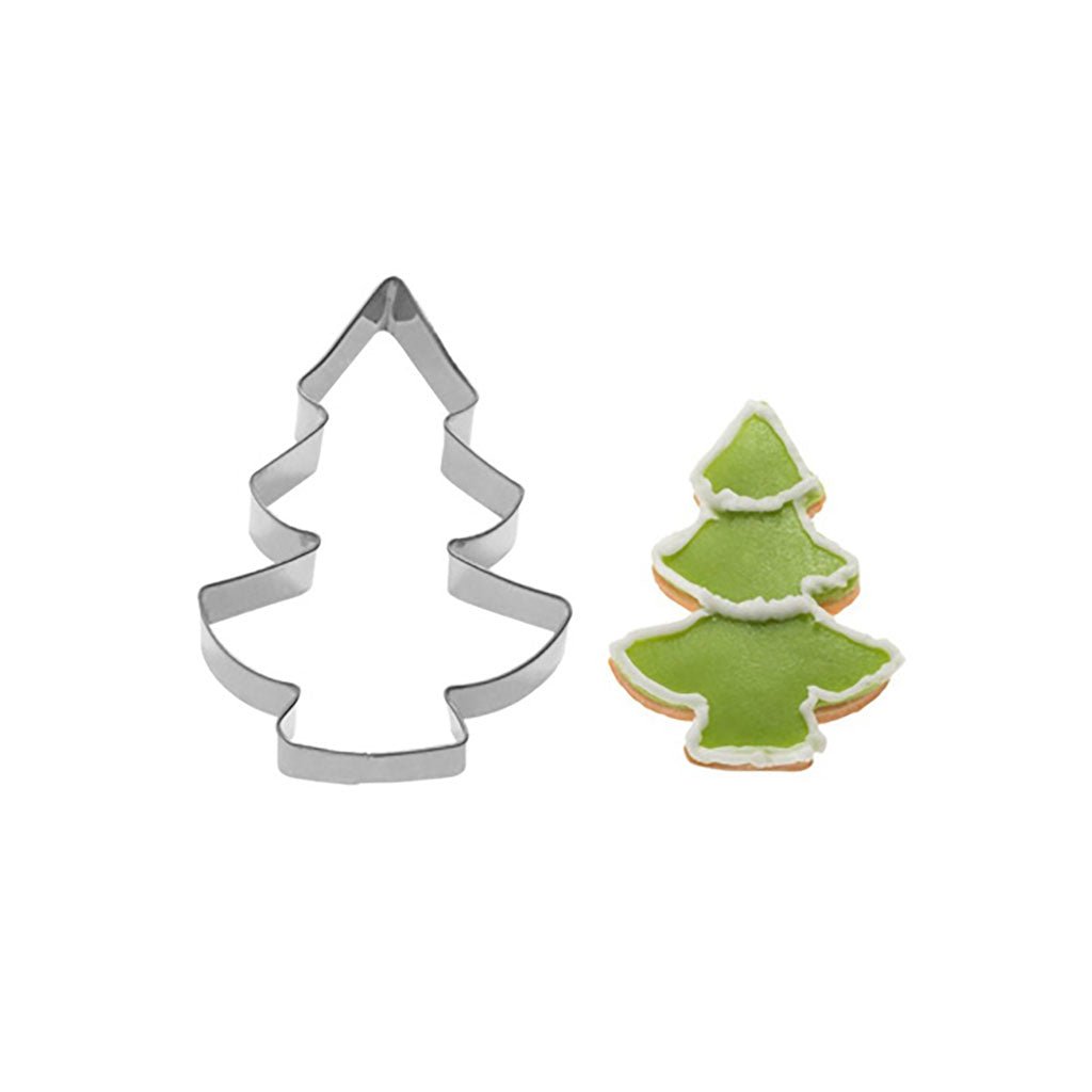 Tree-shaped cookie cutter next to a decorated green cookie.