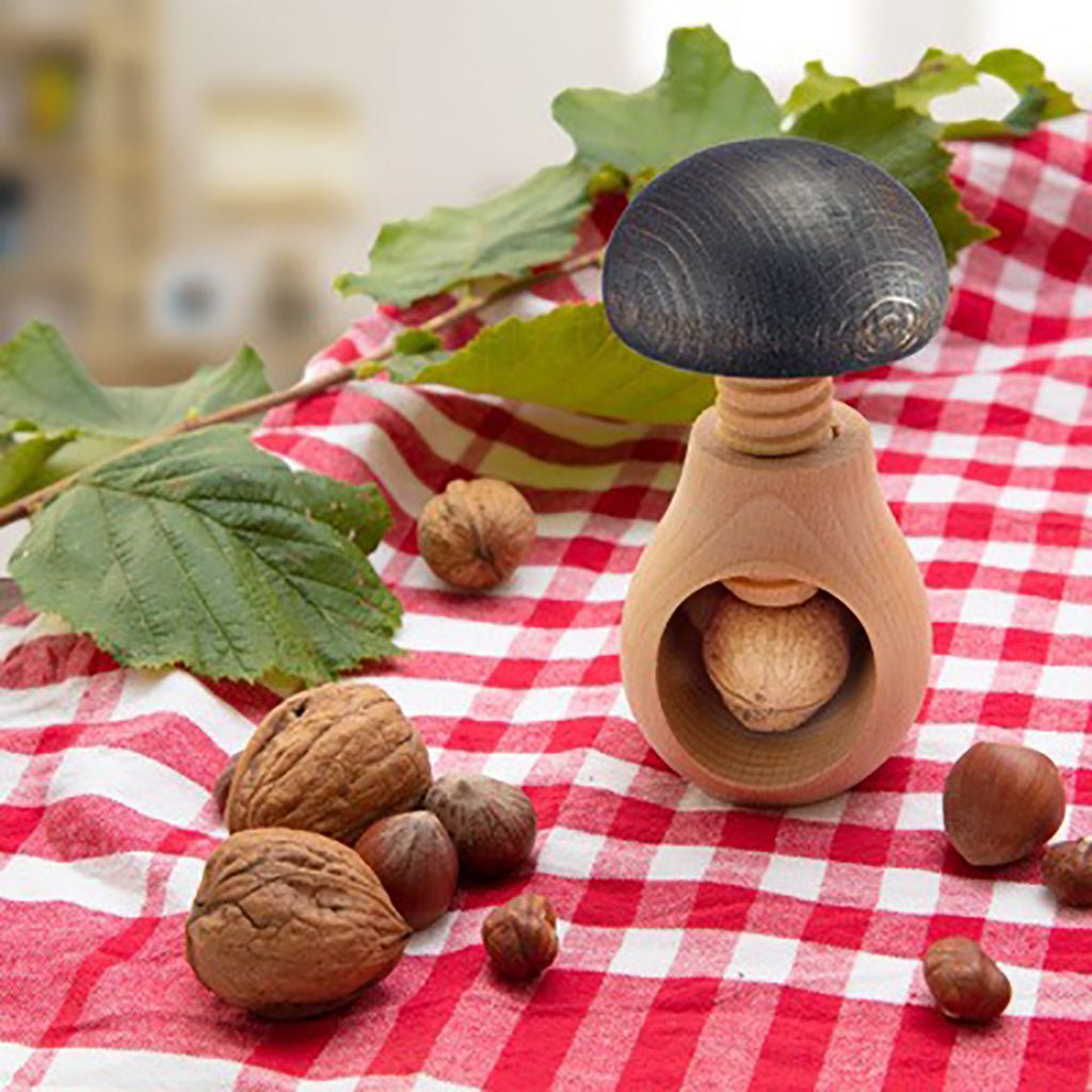 Wooden nutcracker with nuts on a red and white checkered tablecloth
