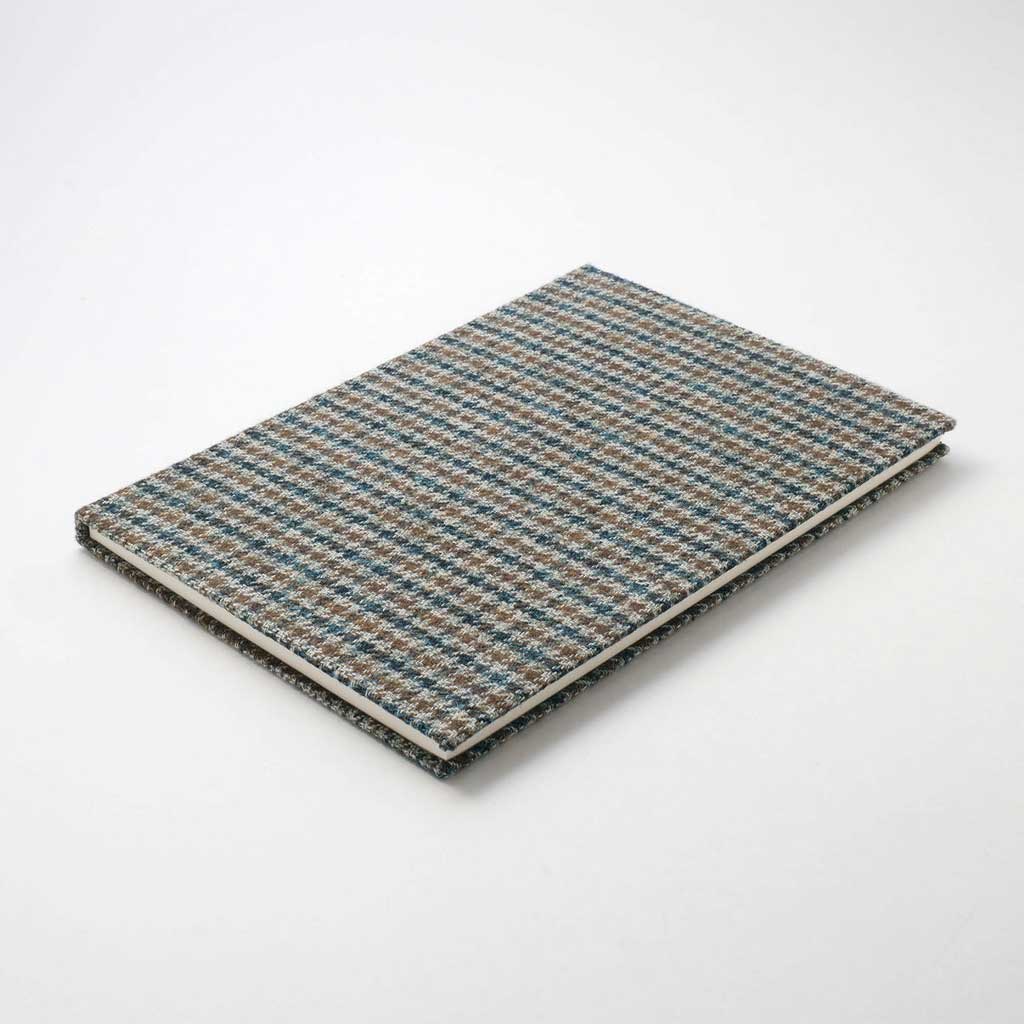 Blue and greenish houndstooth fabric notebook cover on white background