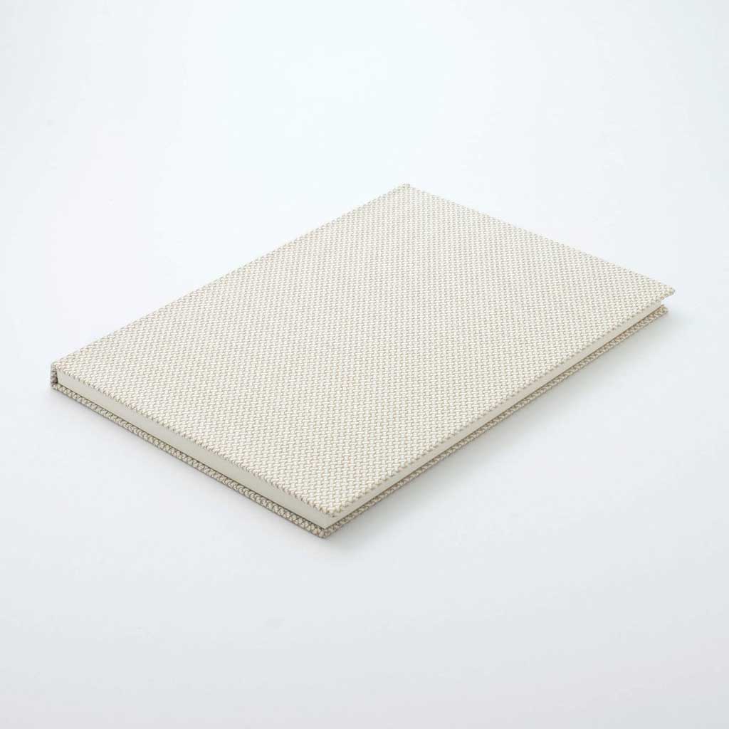 Beige textured notebook on a white background