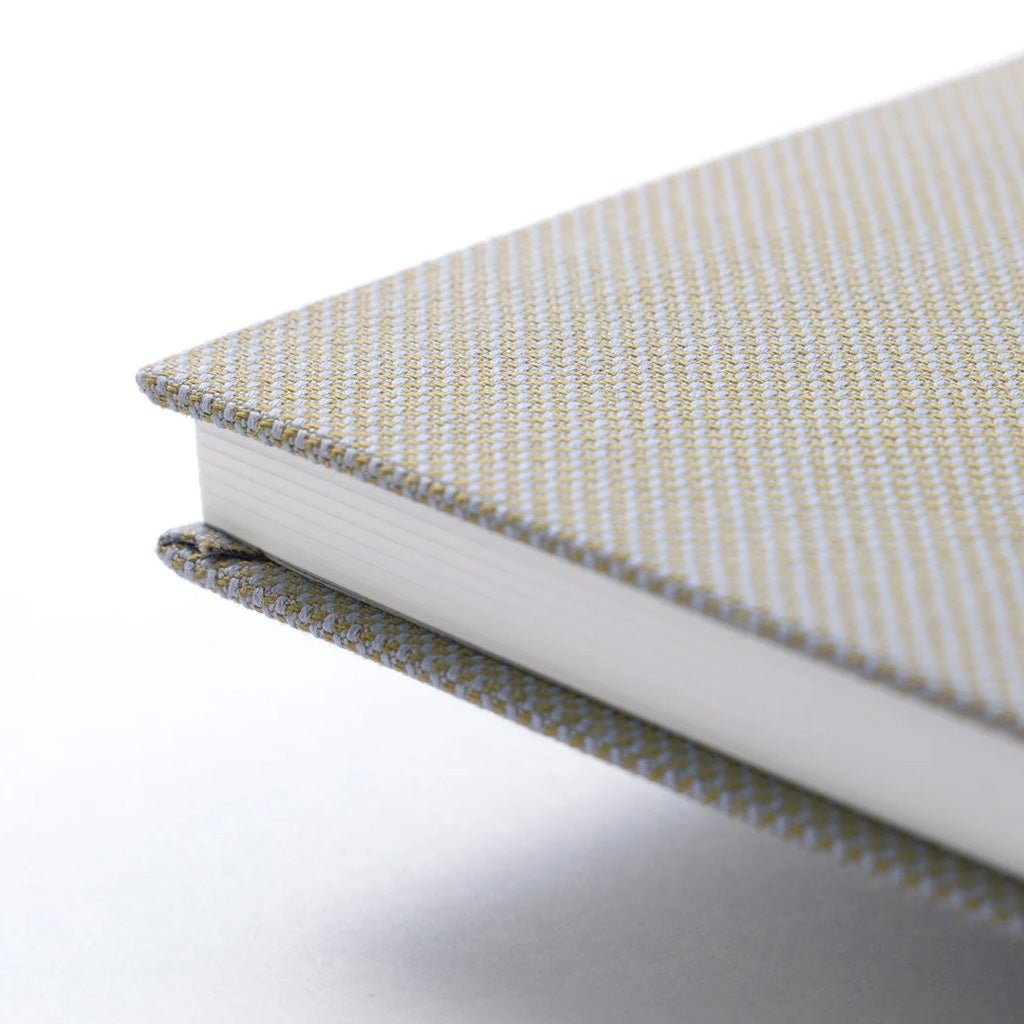 Corner of notebook with woven cotton cover.