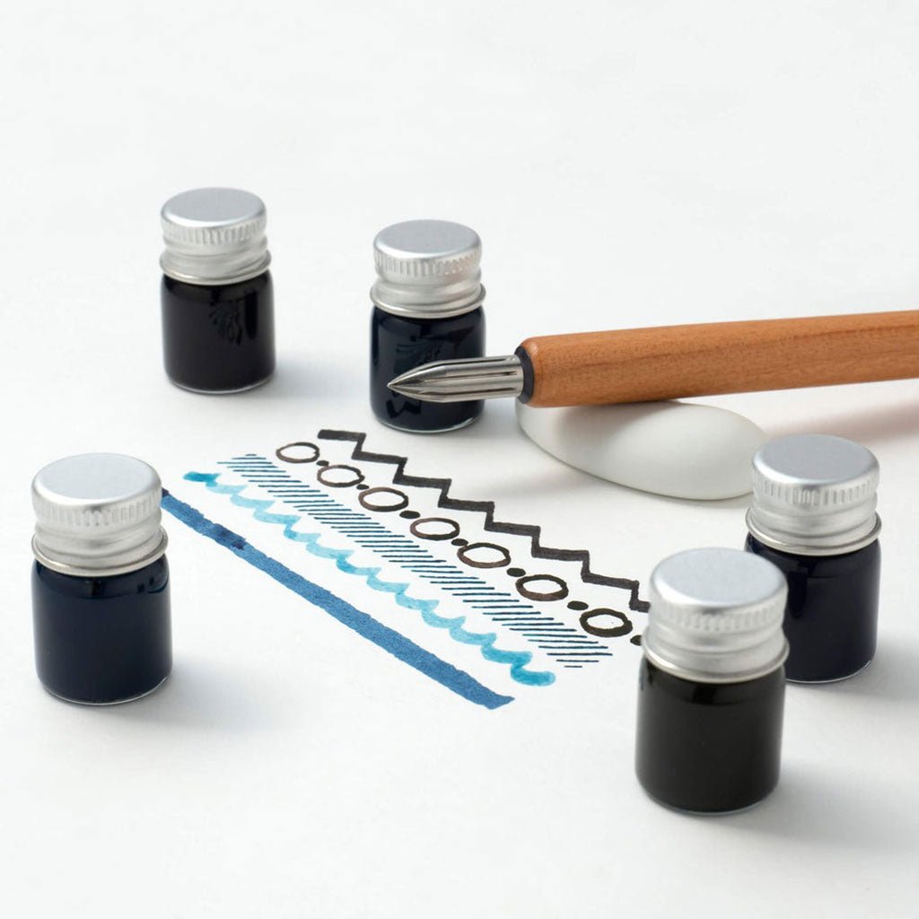 Ink bottles with a dip pen and ink swatches on a white background