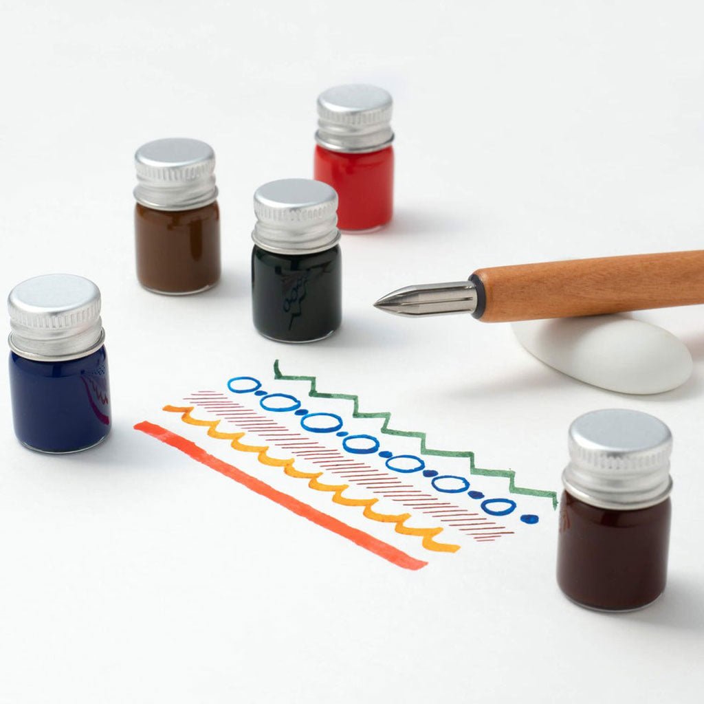 Set of ink bottles with a pen and colored lines on a white background