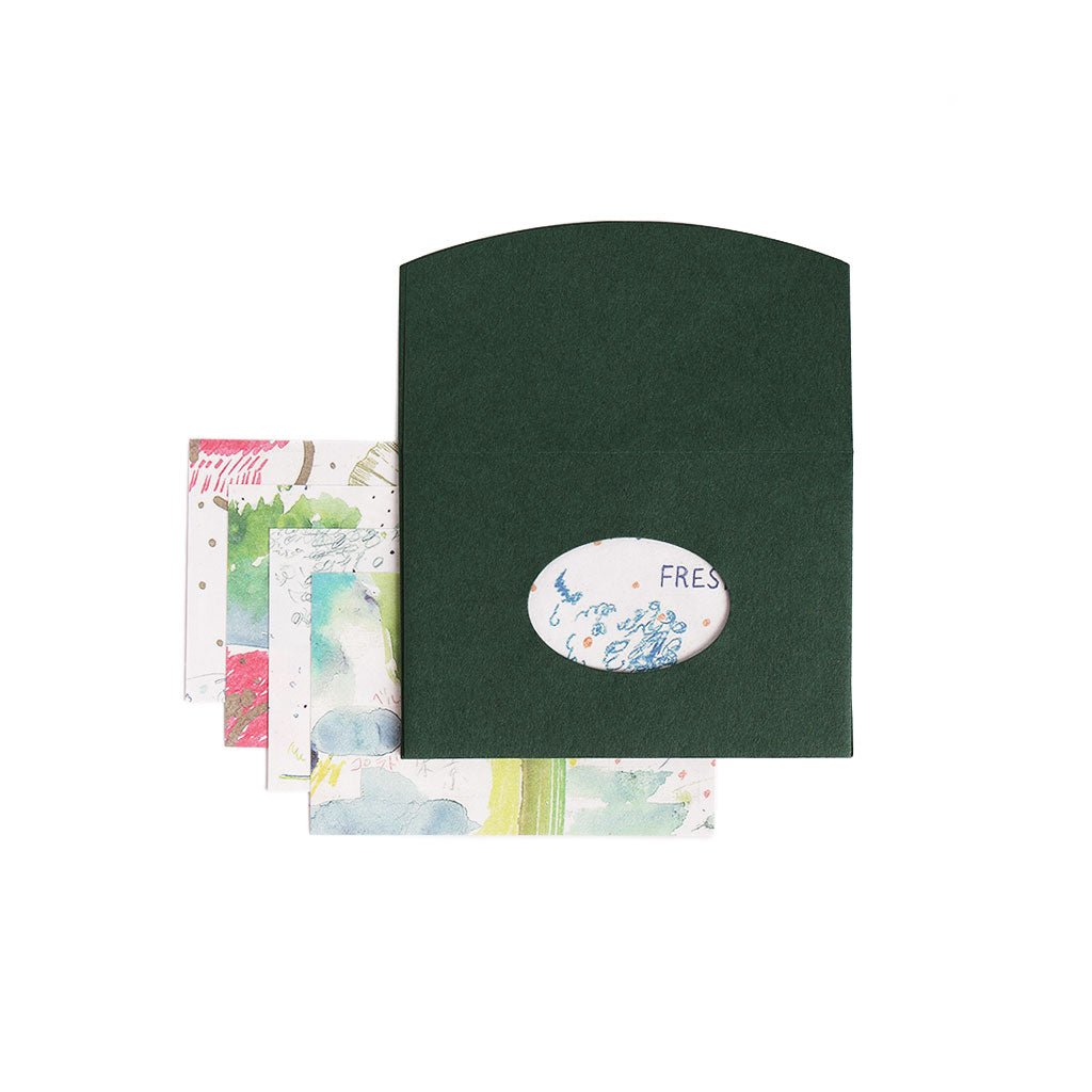 Green envelope with oval cutout, surrounded by watercolor letter papers on a white background