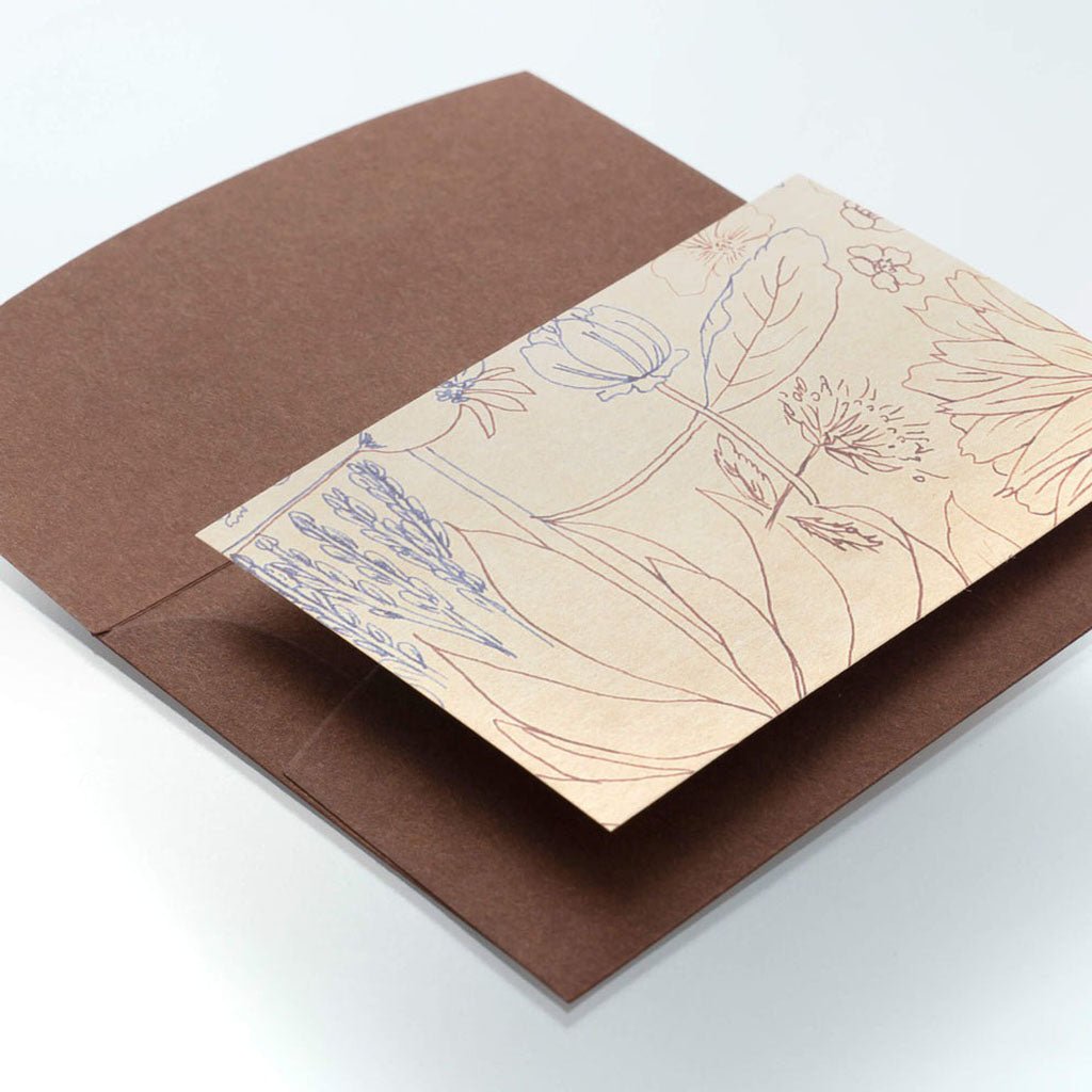 Brown envelope with a floral card on a white background