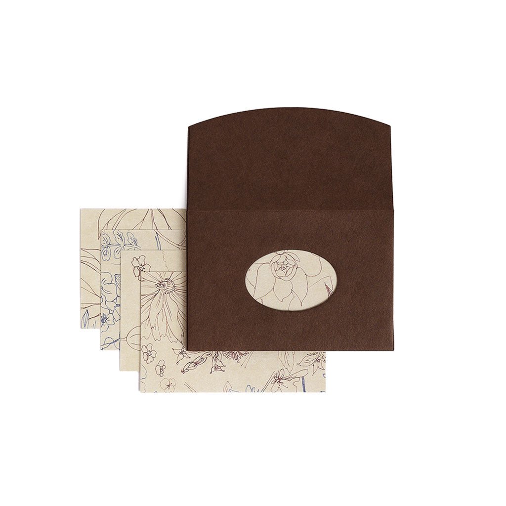 Brown envelope with cutout and letter papers with floral design on a white background