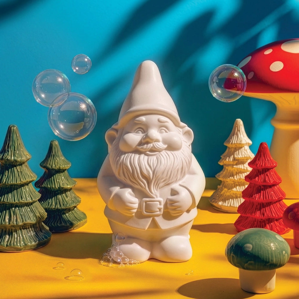 A white gnome-shaped soap in decorative scene with bubbles and tree figurines.