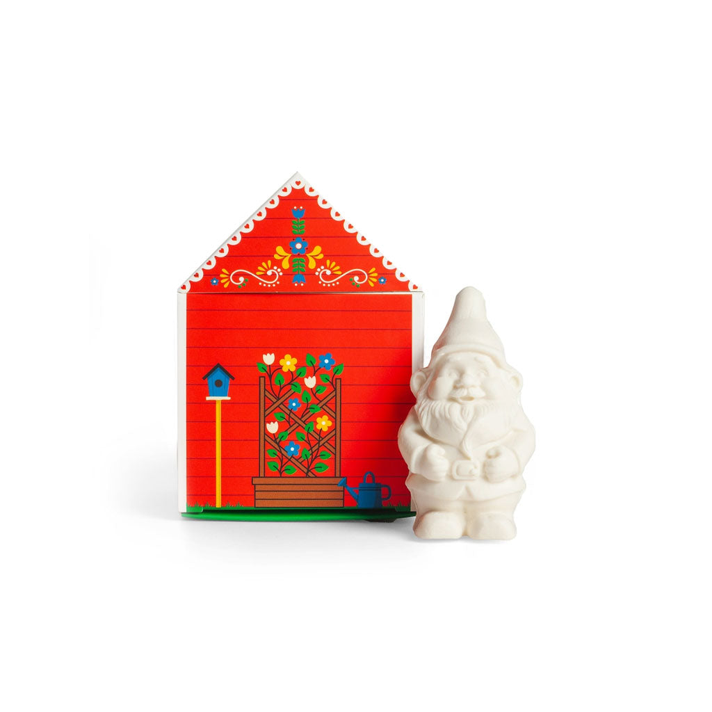 Small gnome-shaped soap bar next to decorative red cottage box.
