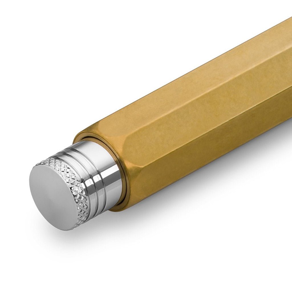 Close up of silver push button on brass pencil