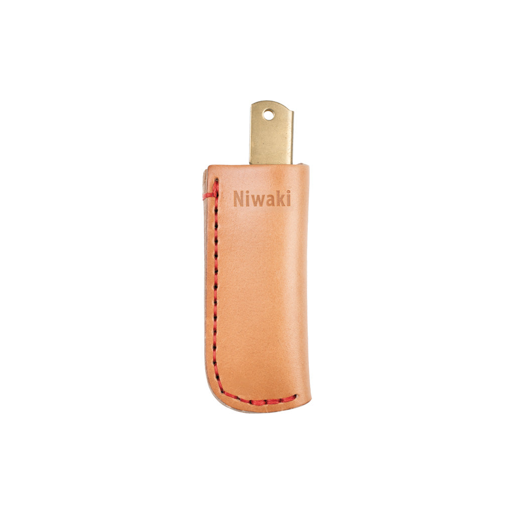 Folding knife inside beige leather knife sheath with red stitching and Niwaki branding on white background