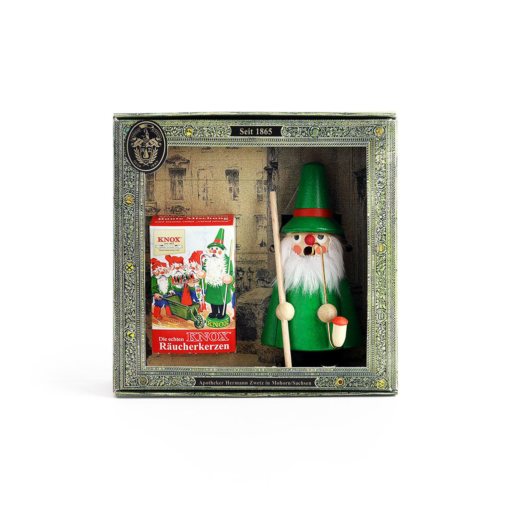 A boxed gift set featuring a traditional German wooden gnome incense burner and a small box of incense cones.