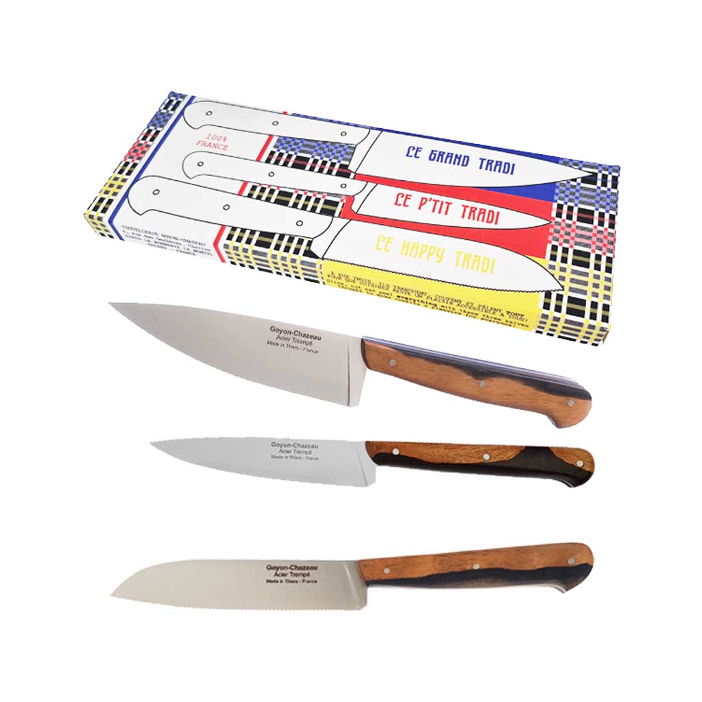 Set of three Goyon-Chazeau two-toned knives with ebony sapwood handle and stainless steel blade on white background next to colorful packaging
