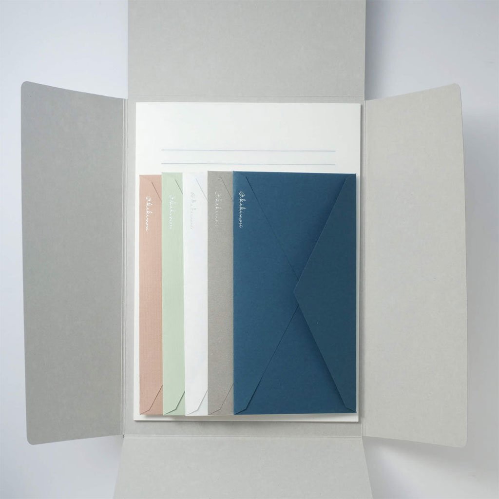 Set of stationery items including envelopes and letter papers in a display case.