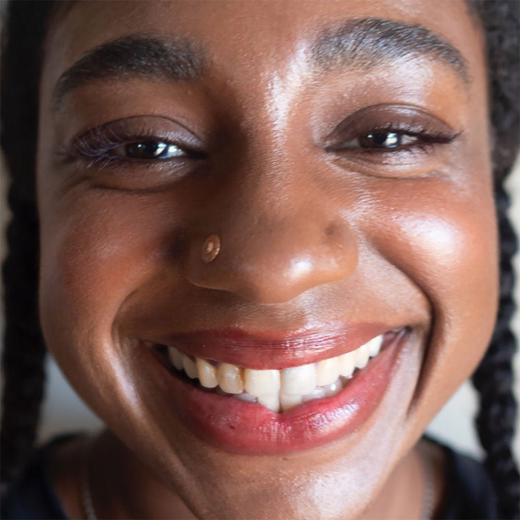 A person wearing the lip and cheek stain