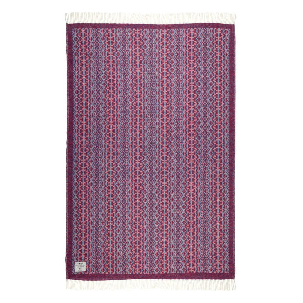 Purple and red patterned blanket with white border on a white background