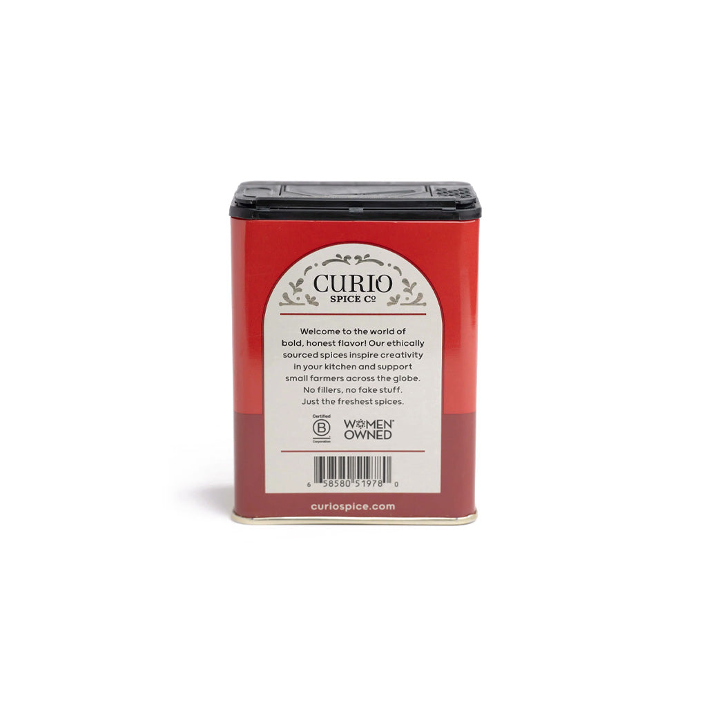Red tin of Magic Salt by Curios Spice company on white background