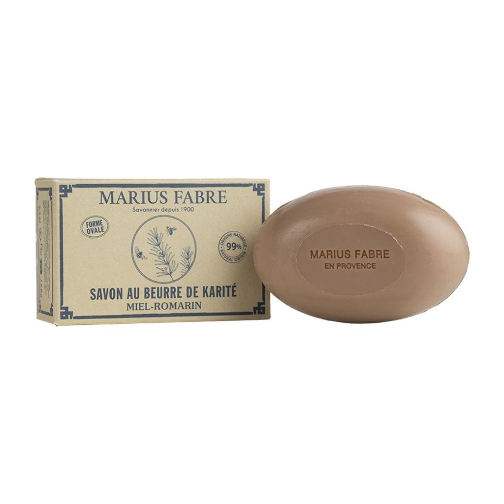 An oval-shaped bar of soap next to a branded paper box.
