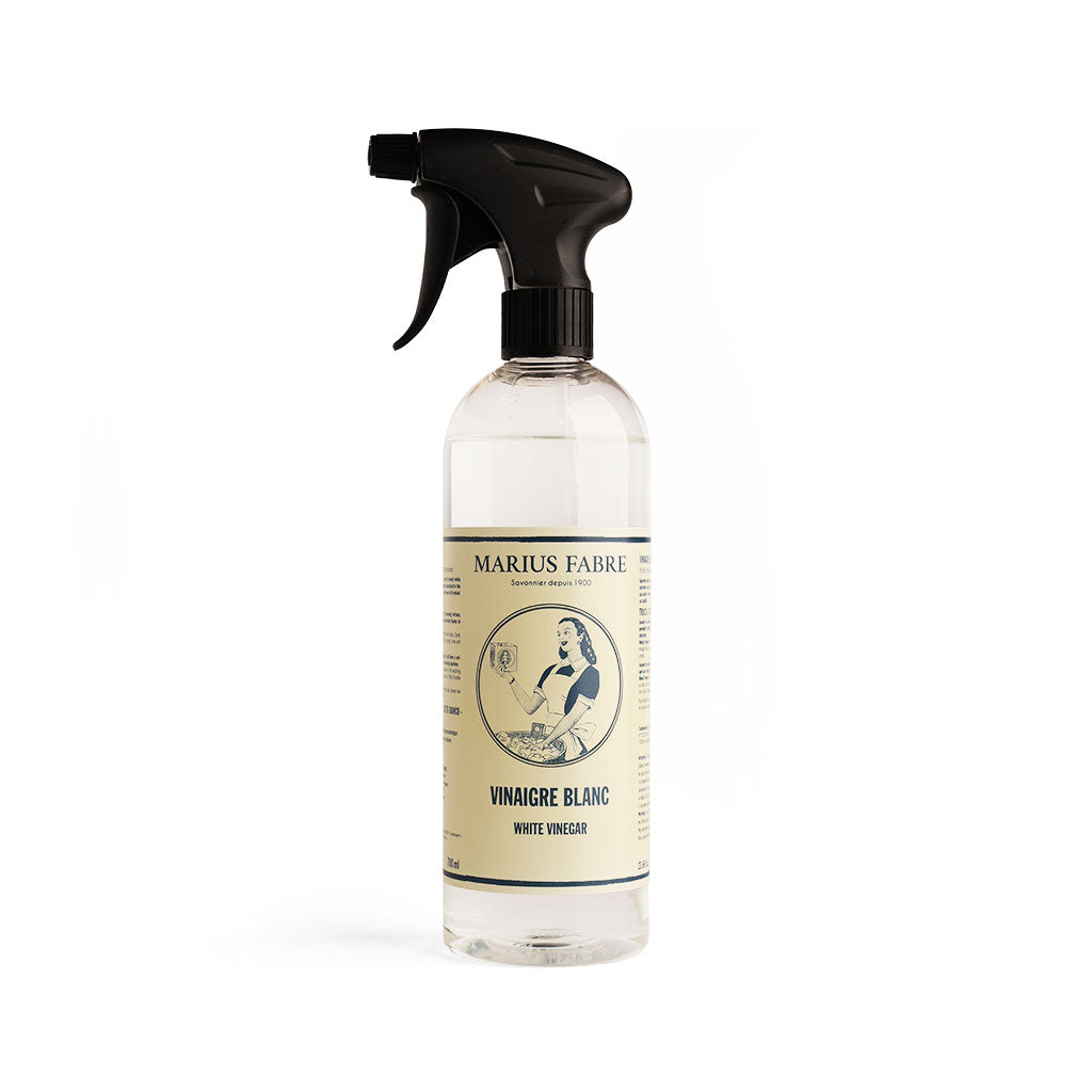 A clear plastic spray bottle of Marius Fabre White Vinegar with a black trigger spray top and a cream-colored label, set against a plain white background.