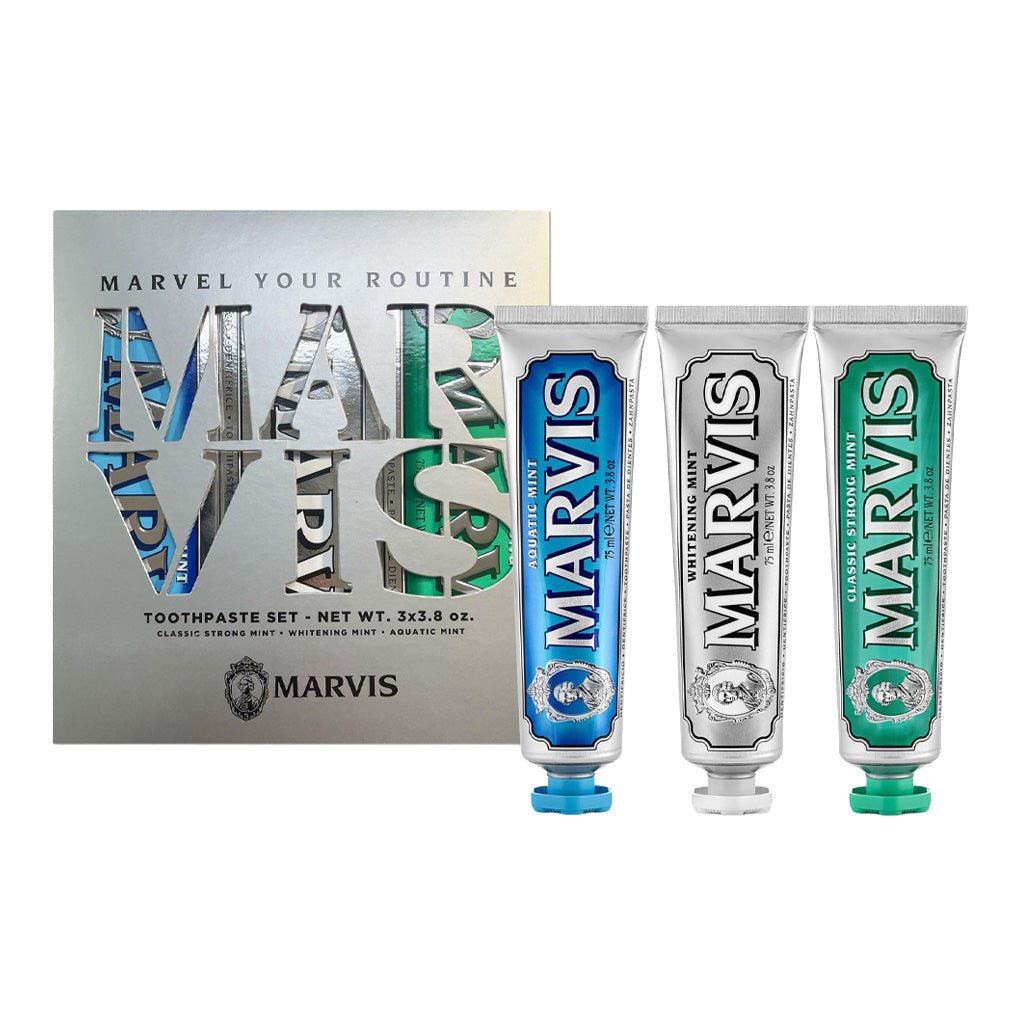 Marvis Toothpaste trio set with box next to toothpaste tubes.