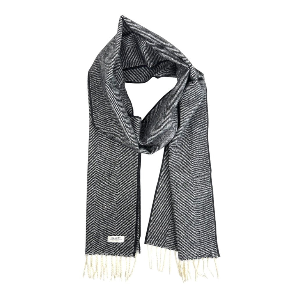 A black merino lambswool scarf in a loop.