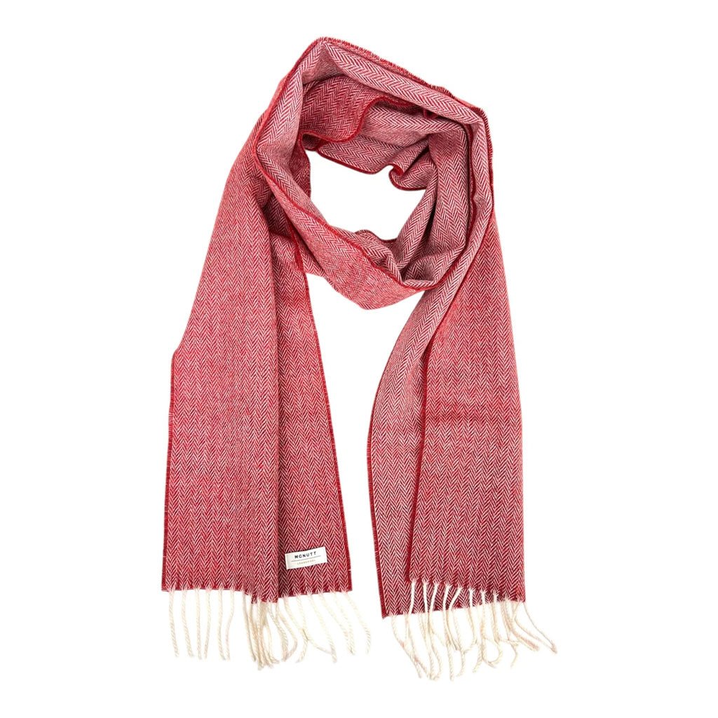 A textured red woven scarf with white fringe.