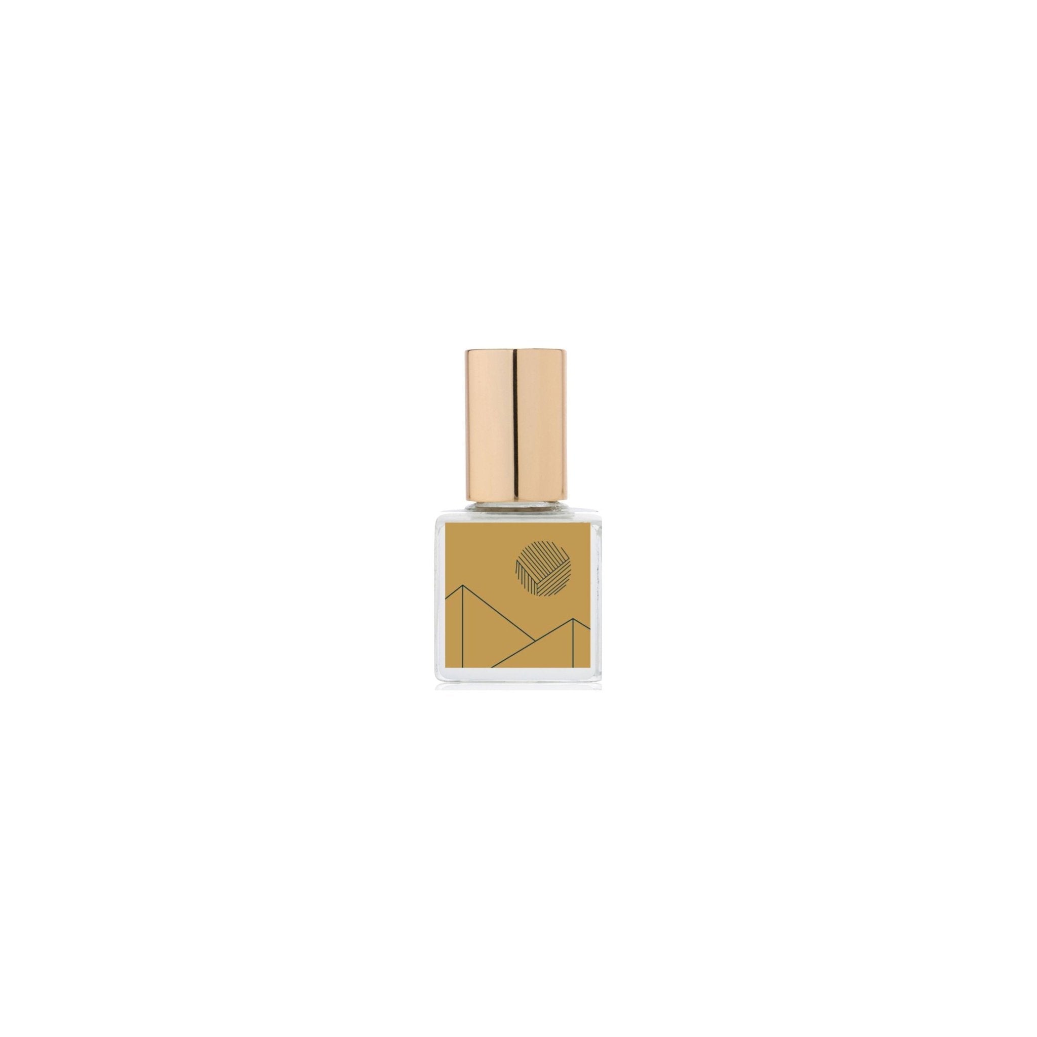 Gold perfume bottle with geometric design on a white background